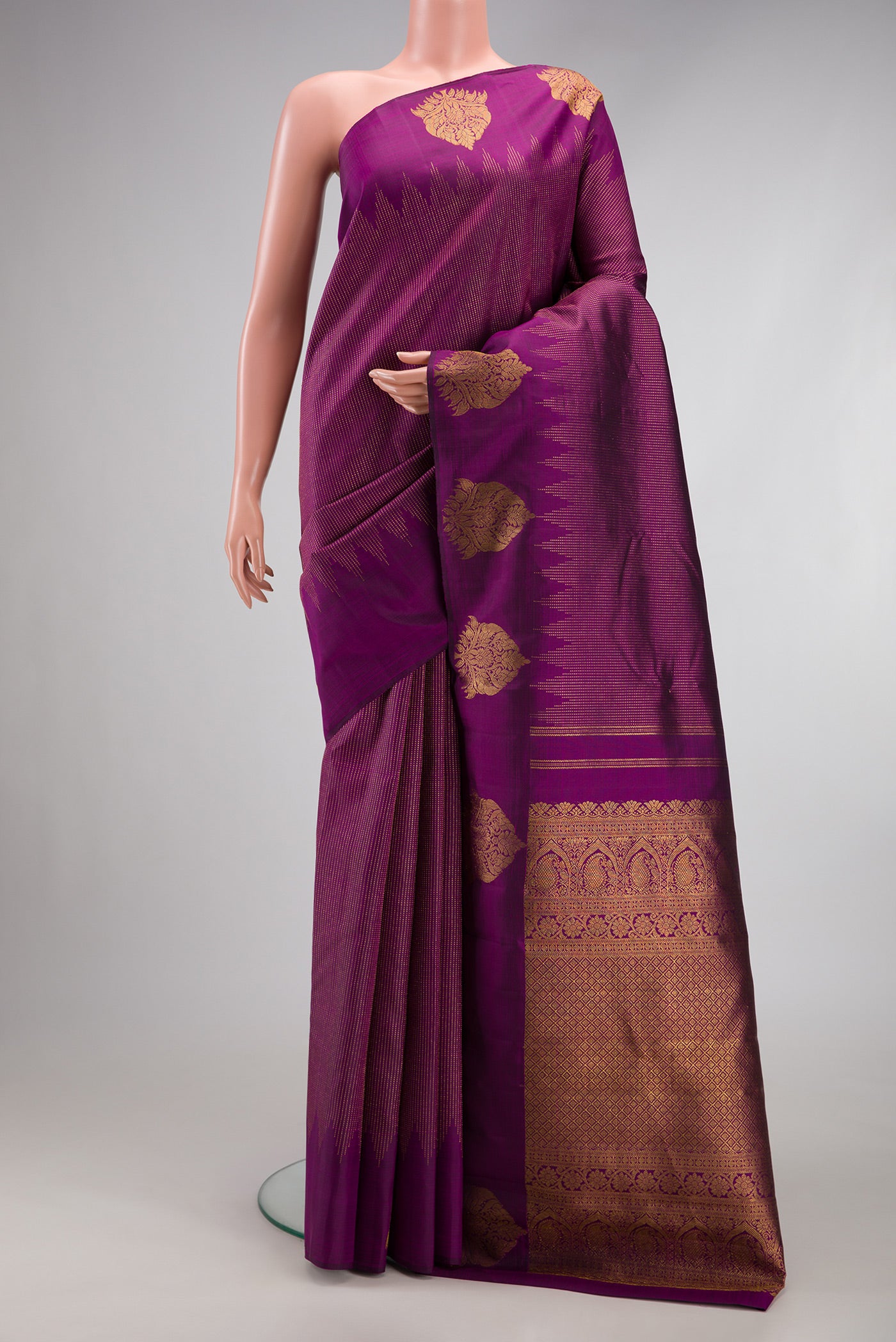Purple Kanjivaram Silk Saree with Stripes on the body and Fancy Border.  displayed on a mannequin