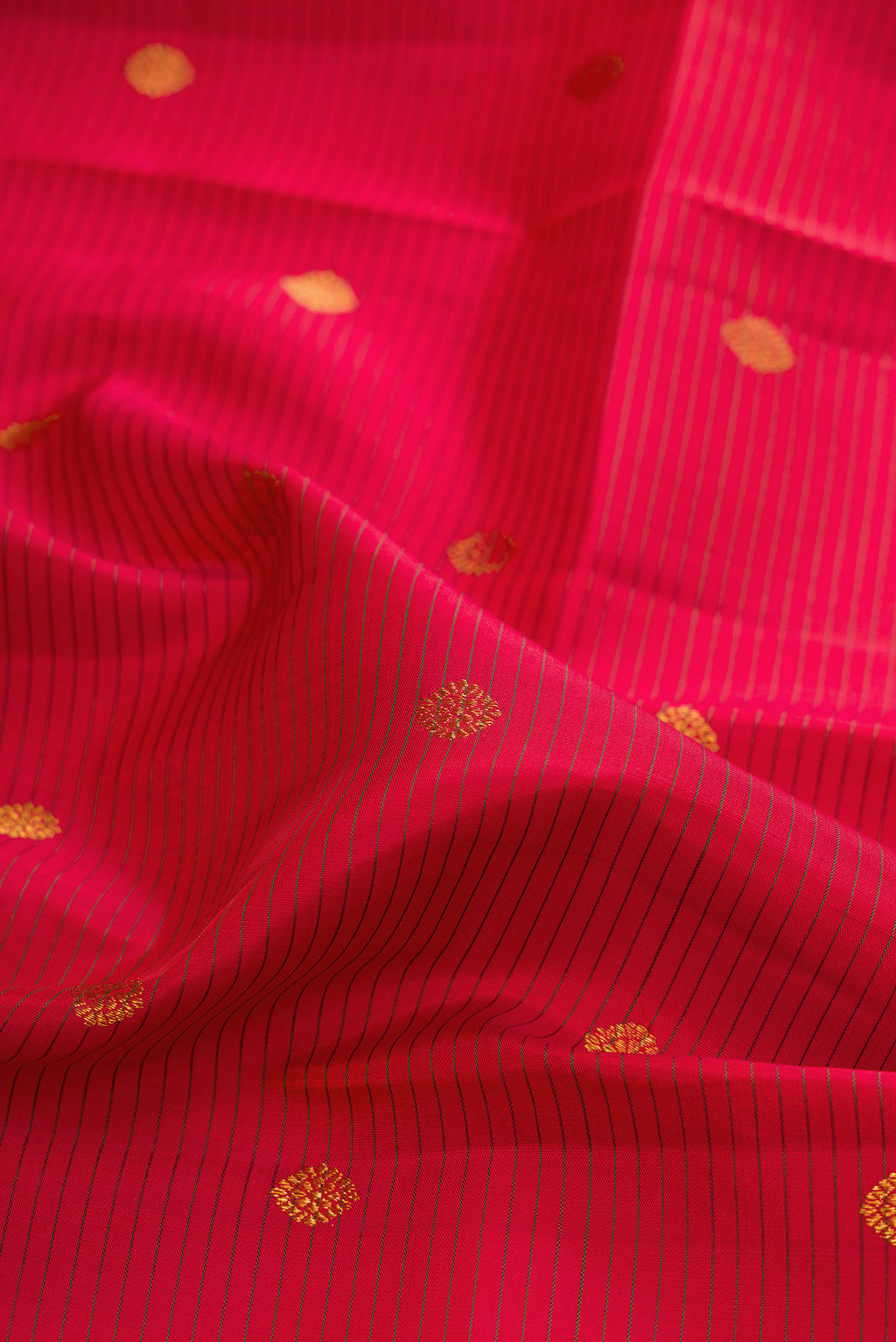 Close up of Maroon Kanjivaram Silk Saree with Stripes on the body and Zari Border.  displaying folds