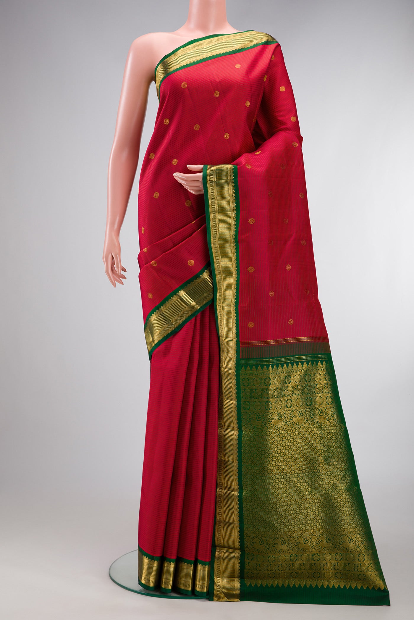 Maroon Kanjivaram Silk Saree with Stripes on the body and Zari Border.  displayed on a mannequin