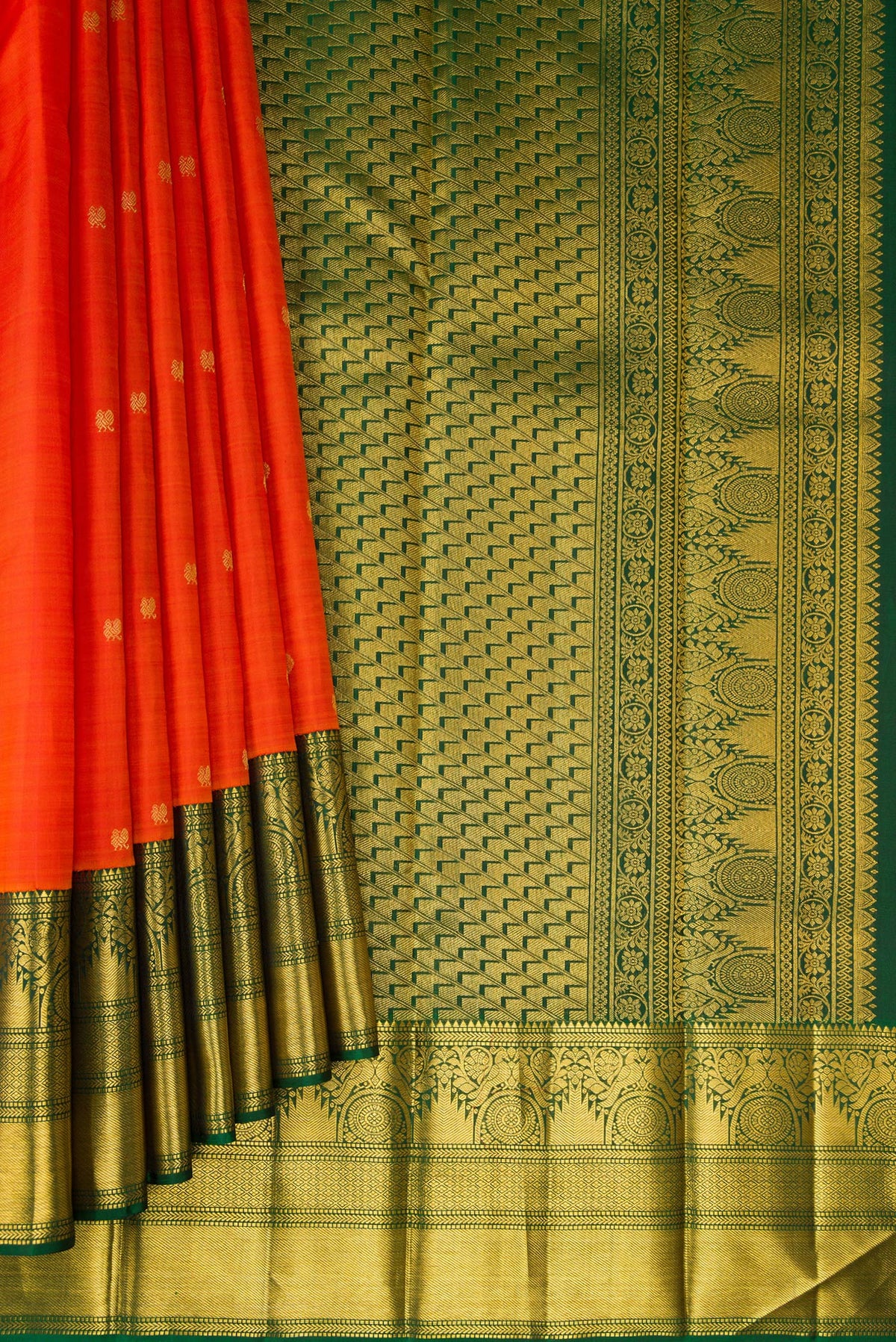 Pleats and pallu of Orange Kanchipuram Silk Saree with Zari Butta on the body and Zari Border. 