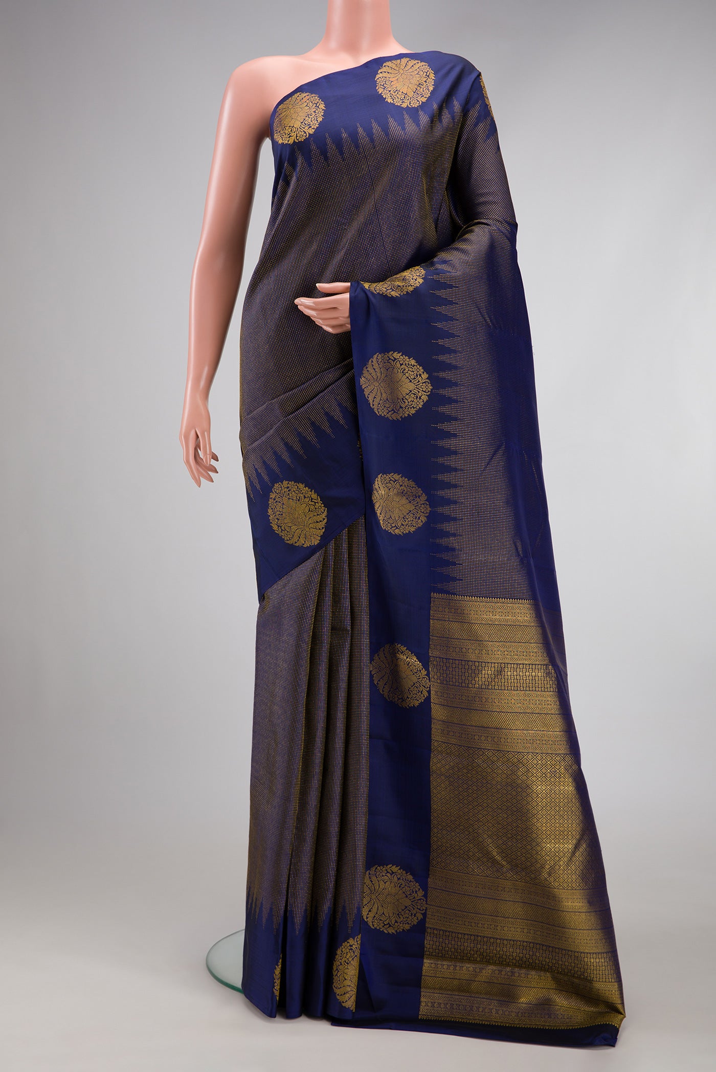 Navy Blue Kanjivaram Silk Saree with Stripes on the body and Fancy Border.  displayed on a mannequin