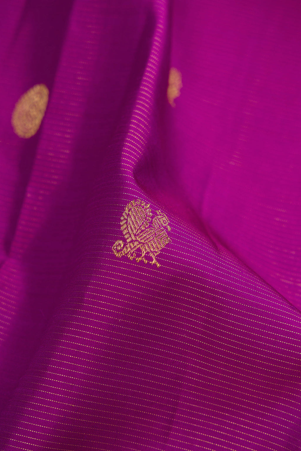 Close up of Purple Dual Tone Kanchipuram Silk Saree with Zari Butta on the body and Zari Border.  displaying folds