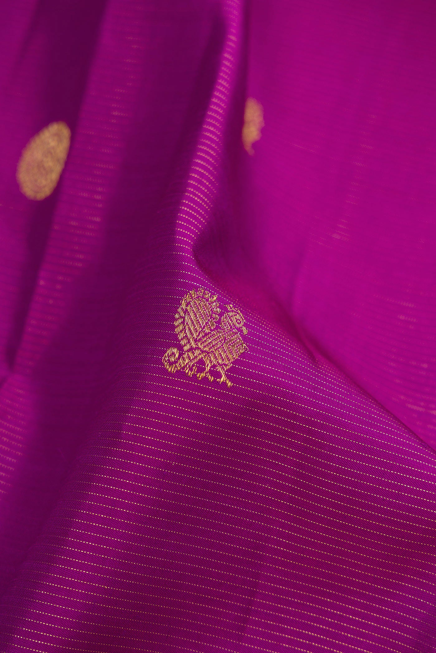 Close up of Purple Dual Tone Kanchipuram Silk Saree with Zari Butta on the body and Zari Border.  displaying folds
