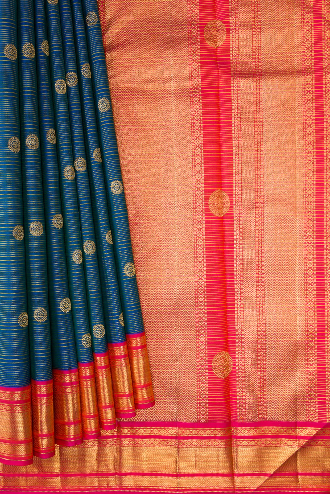 Pleats and pallu of Peacock Blue Kanchipuram Silk Saree with Zari Butta on the body and Zari Border. 