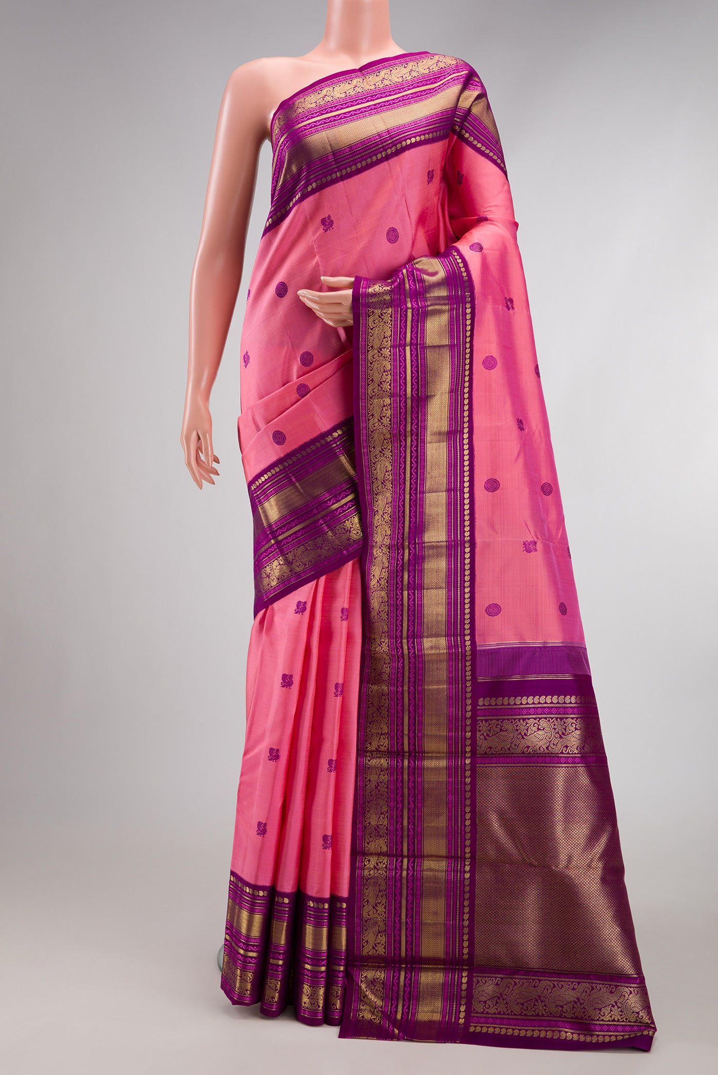 Pure Silk Pure Zari Pink Kanchipuram Saree with Thread Butta on the body and Zari Border.  displayed on a mannequin