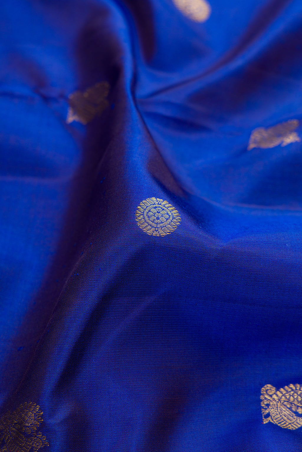 Close up of Royal Blue Dual Tone Kanjivaram Silk Saree with Zari Butta on the body and Zari Border.  displaying folds