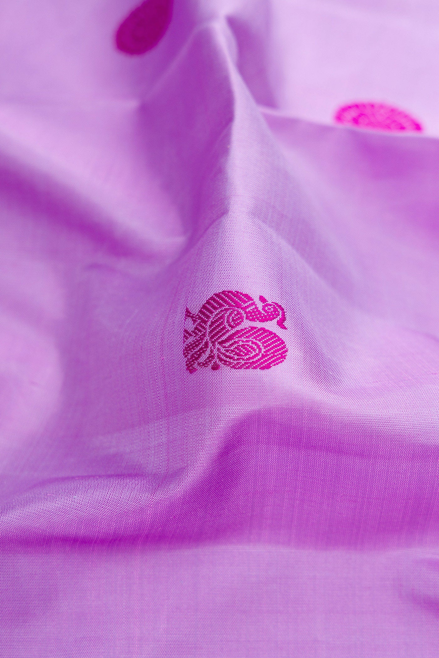 Close up of Lavender Dual Tone Kanjivaram Silk Saree with Thread Butta on the body and Zari Border.  displaying folds