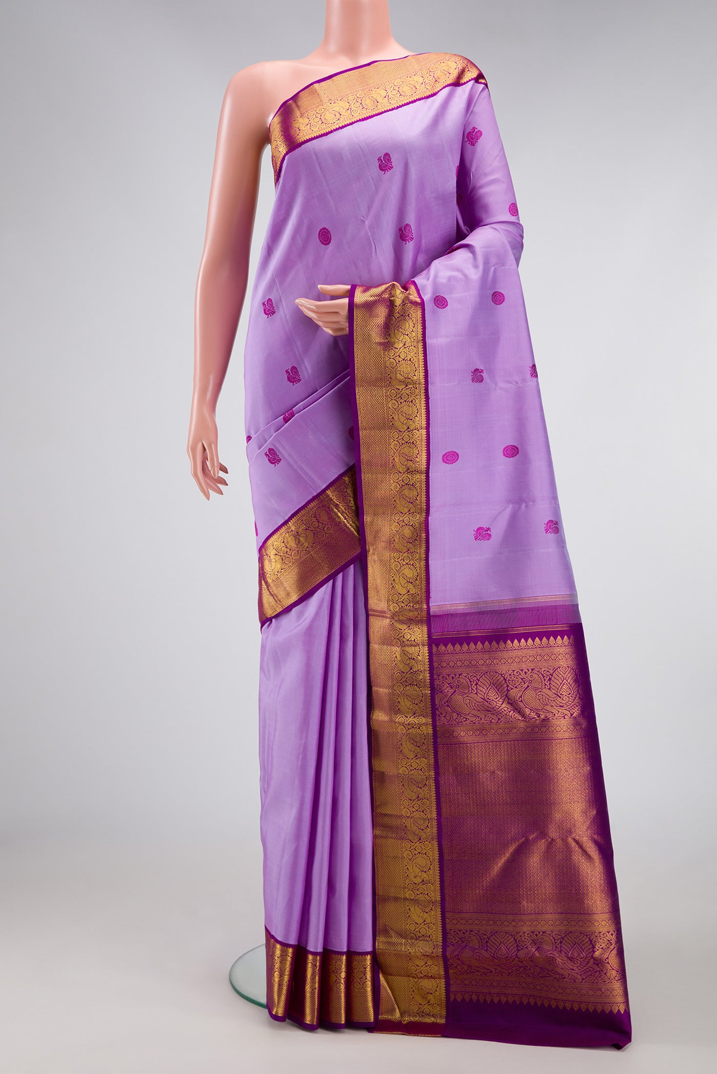 Lavender Dual Tone Kanjivaram Silk Saree with Thread Butta on the body and Zari Border.  displayed on a mannequin