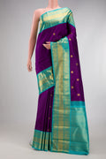 Purple Kanjivaram Silk Saree with Zari Butta on the body and Zari Border.  displayed on a mannequin