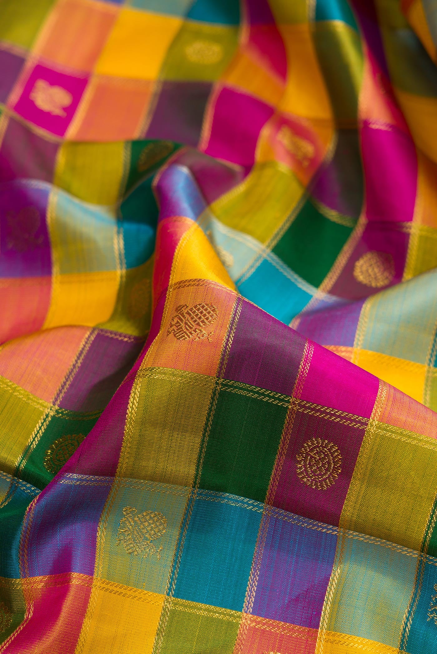 Close up of Multi Color Kanchipuram Silk Saree with Checked design on the body and Zari Border.  displaying folds