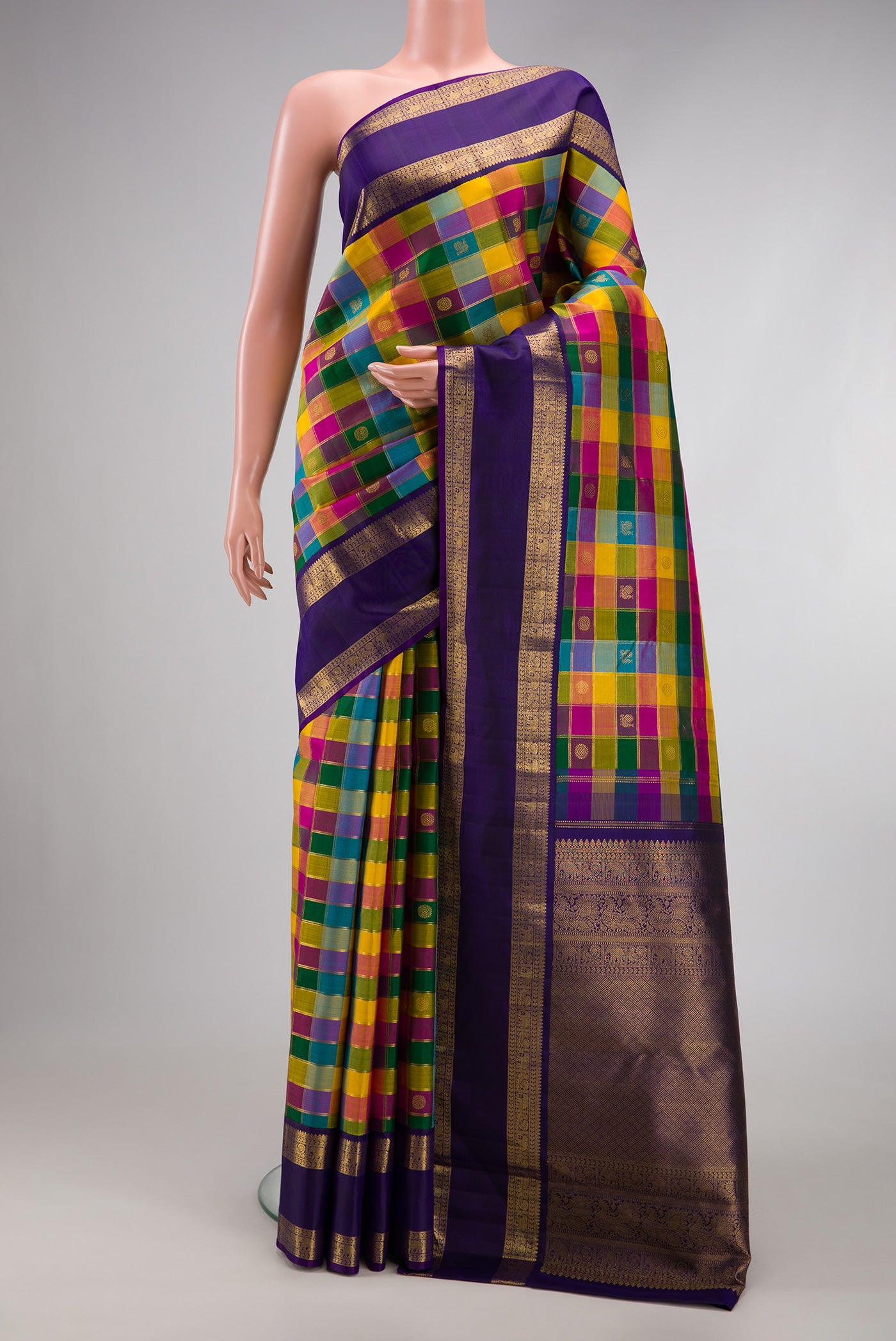 Multi Color Kanchipuram Silk Saree with Checked design on the body and Zari Border.  displayed on a mannequin