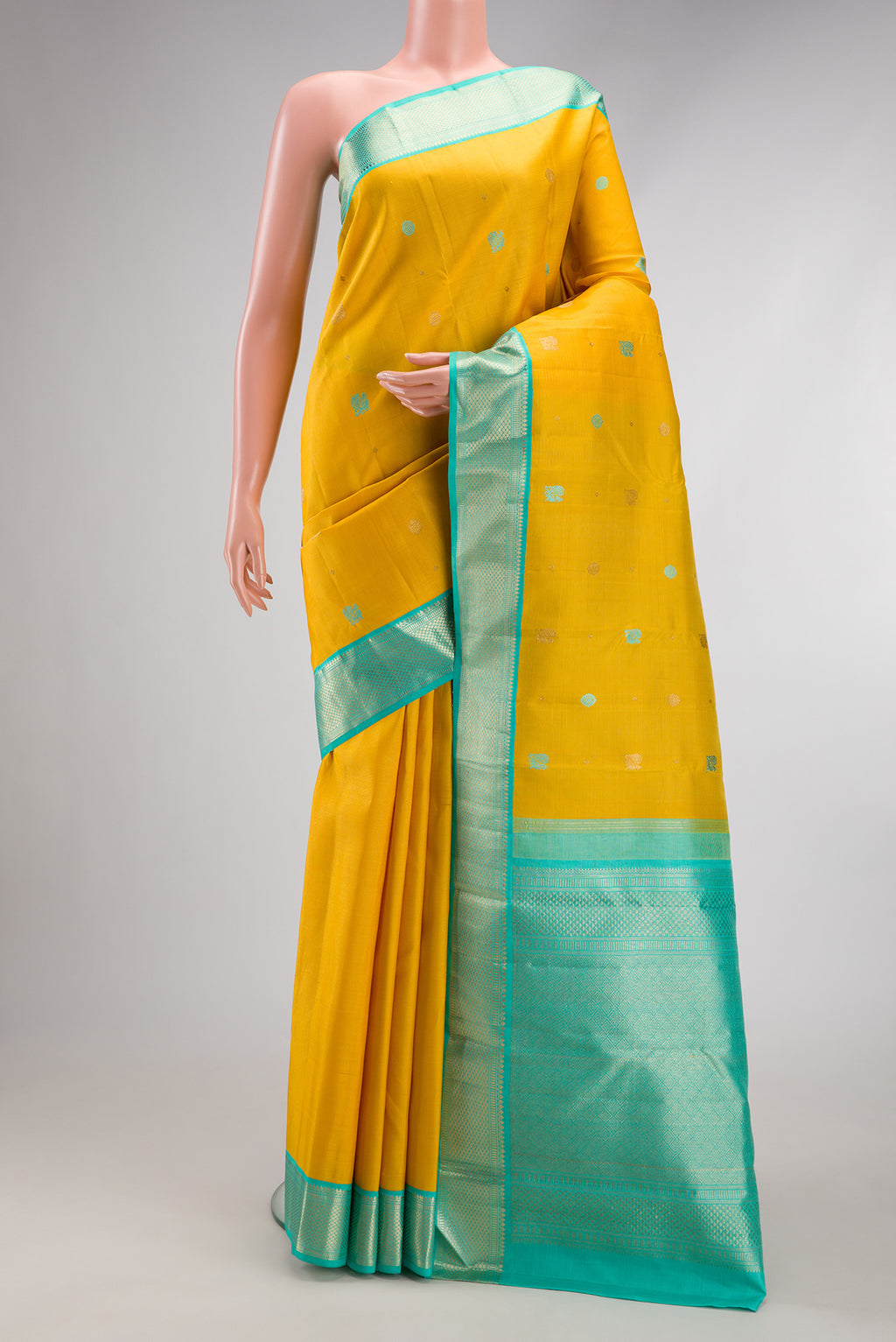 Pure Silk Pure Zari Yellow Kanchipuram Saree with Thread Butta on the body and Zari Border.  displayed on a mannequin
