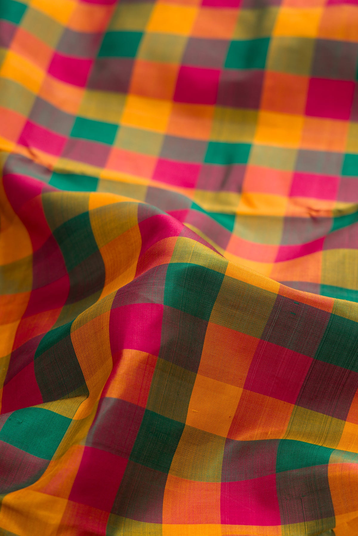 Close up of Pure Silk Multi Color Kanjivaram Nine Yards Saree with Checked design on the body and Zari Border.  displaying folds