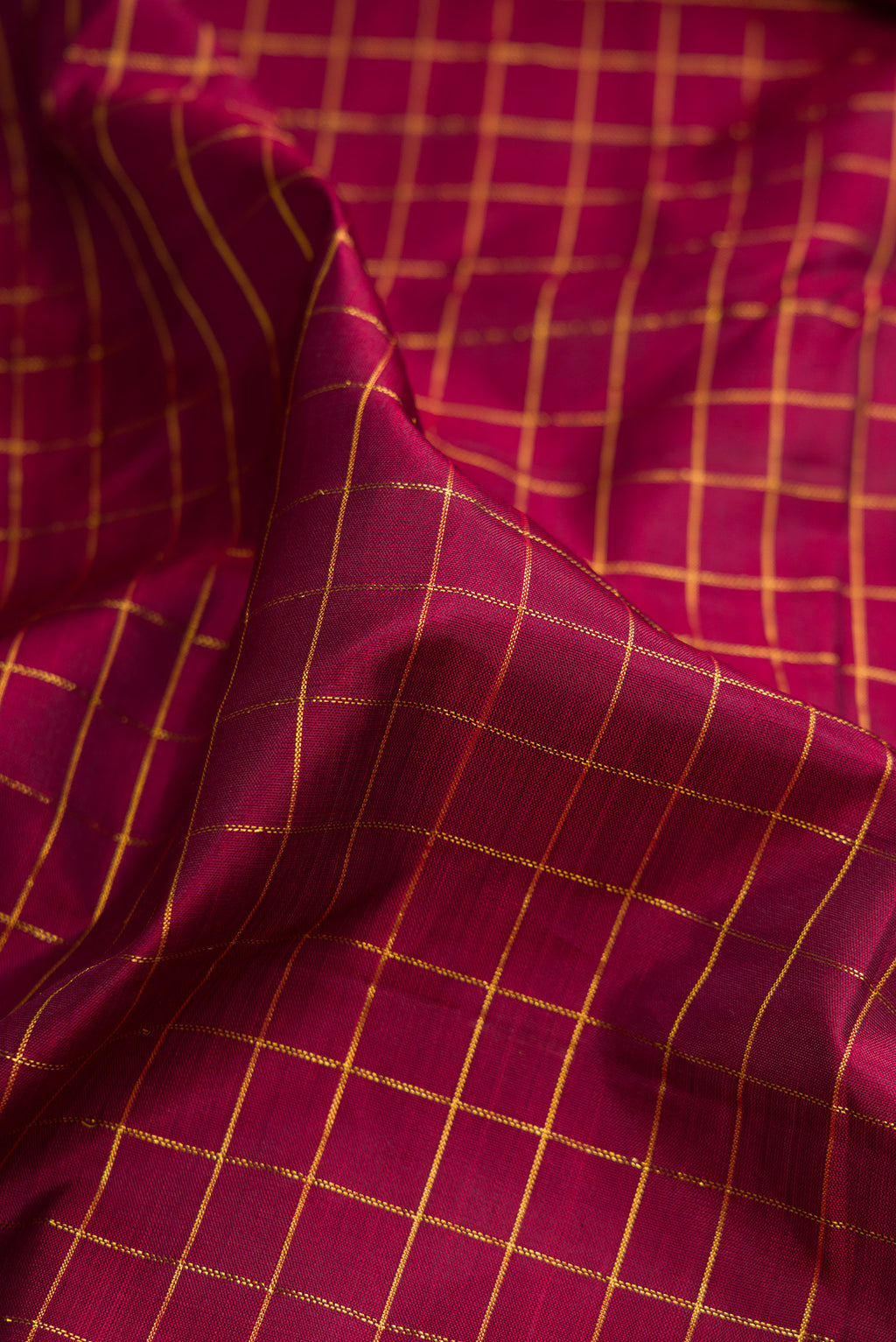 Close up of Pure Silk Maroon Kanchipuram Nine Yards Saree with Checked design on the body and Zari Border.  displaying folds