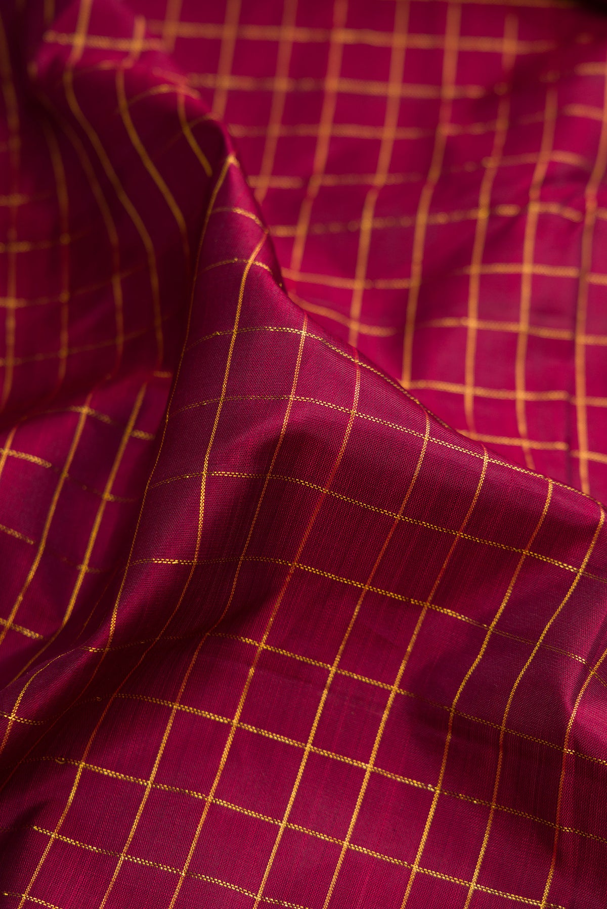 Close up of Pure Silk Maroon Kanchipuram Nine Yards Saree with Checked design on the body and Zari Border.  displaying folds