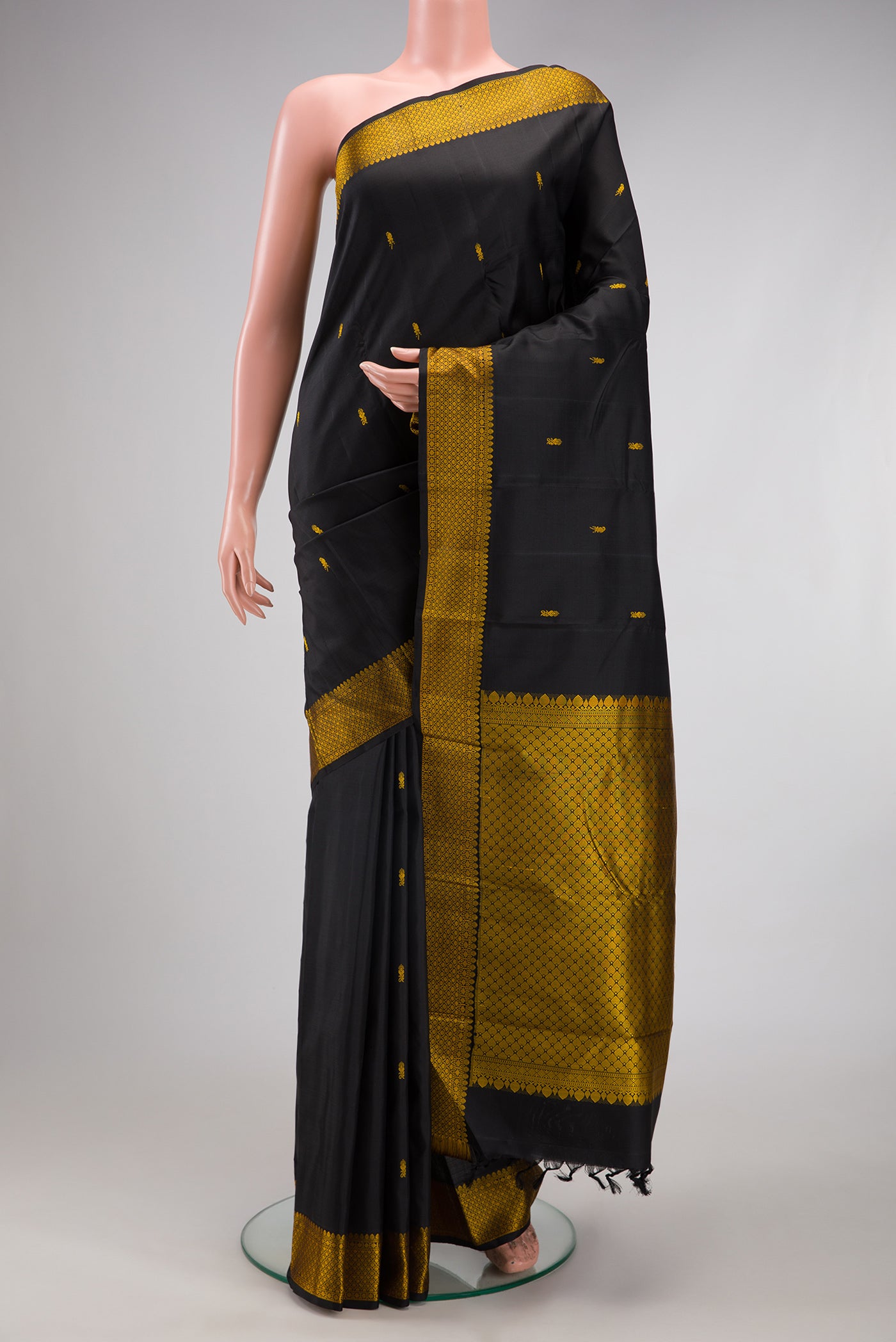 Black Kanchipuram Silk Saree with Thread Butta on the body and Thread Border.  displayed on a mannequin