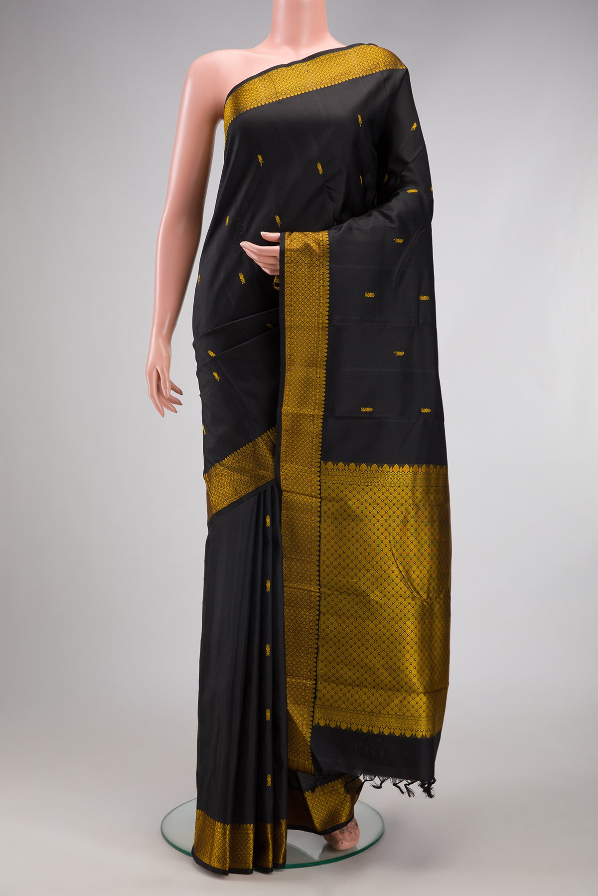 Black Kanchipuram Silk Saree with Thread Butta on the body and Thread Border.  displayed on a mannequin