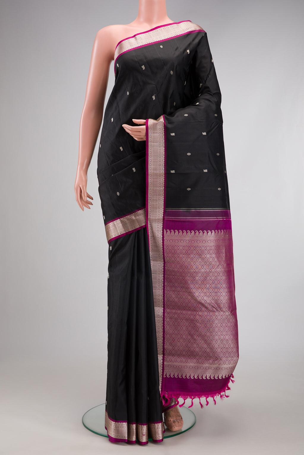 Black Kanchipuram Silk Saree with Thread Butta on the body and Thread Border.  displayed on a mannequin