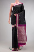 Black Kanchipuram Silk Saree with Thread Butta on the body and Thread Border.  displayed on a mannequin
