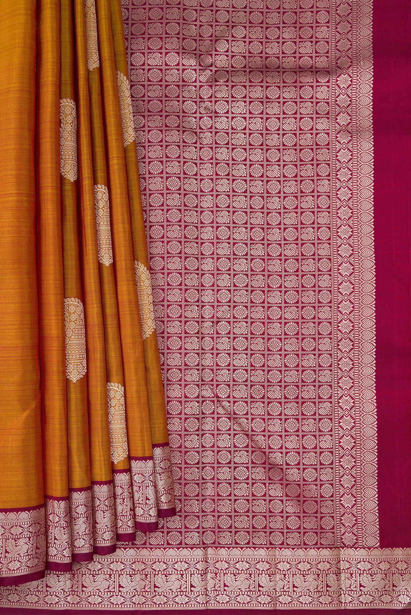 Pleats and pallu of Mustard Kanjivaram Silk Saree with Thread Butta on the body and Thread Border. 