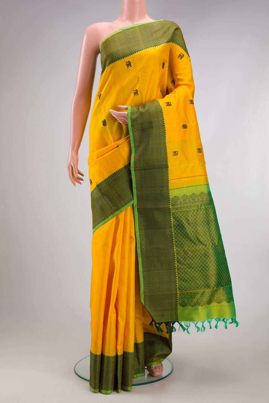 Yellow Kanjivaram Silk Saree with Thread Butta on the body and Thread Border.  displayed on a mannequin