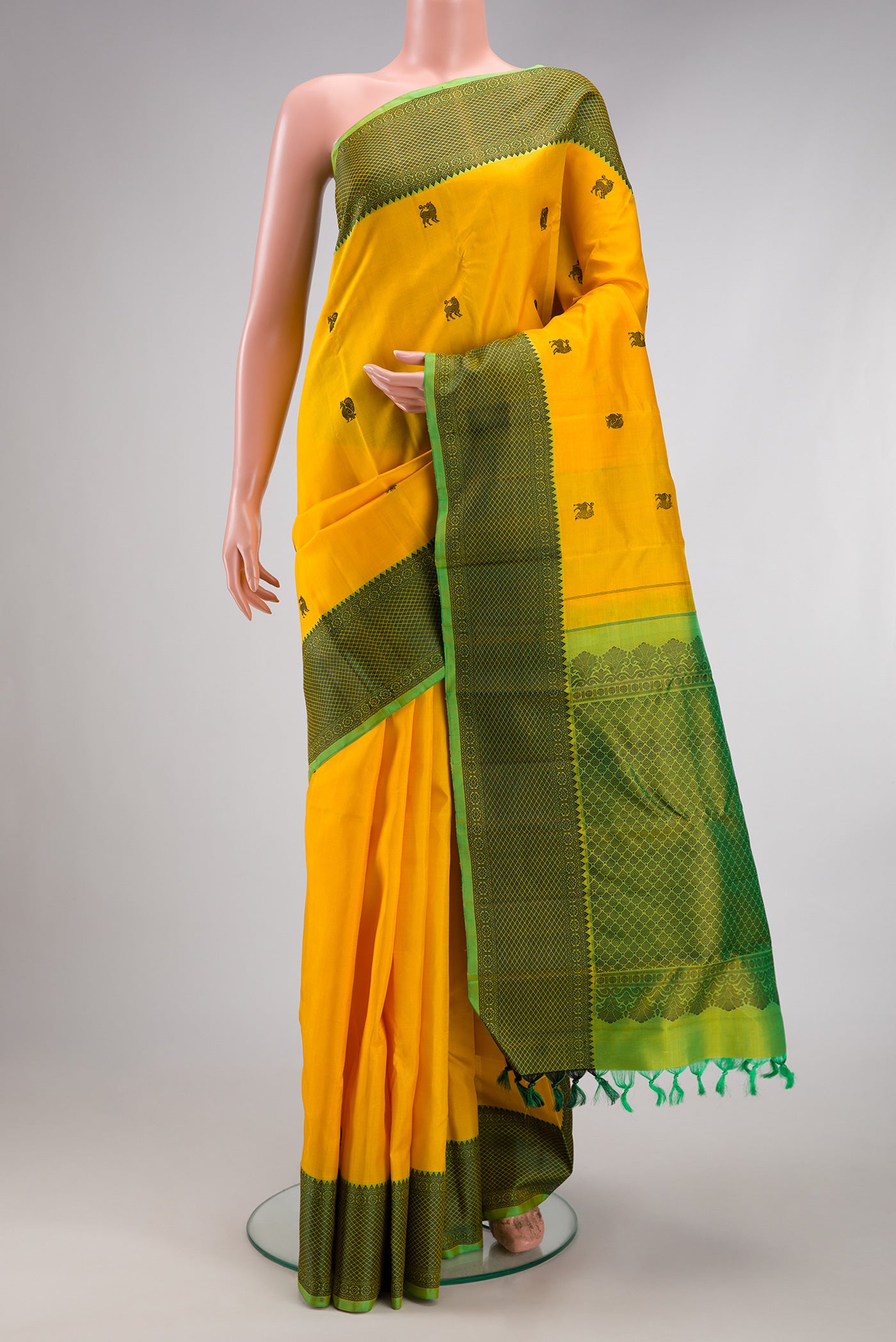 Yellow Kanjivaram Silk Saree with Thread Butta on the body and Thread Border.  displayed on a mannequin