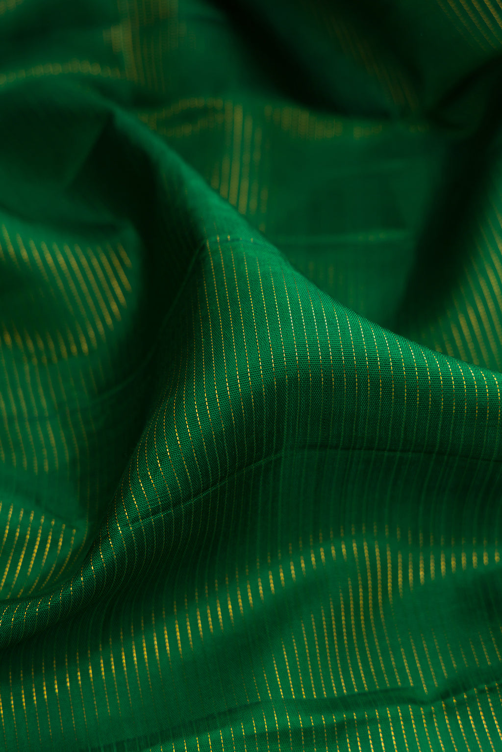 Close up of Pure Silk Green Kanchipuram Nine Yards Saree with Stripes on the body and Zari Border.  displaying folds