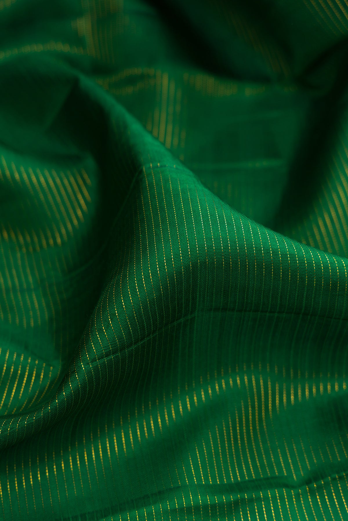 Close up of Pure Silk Green Kanchipuram Nine Yards Saree with Stripes on the body and Zari Border.  displaying folds