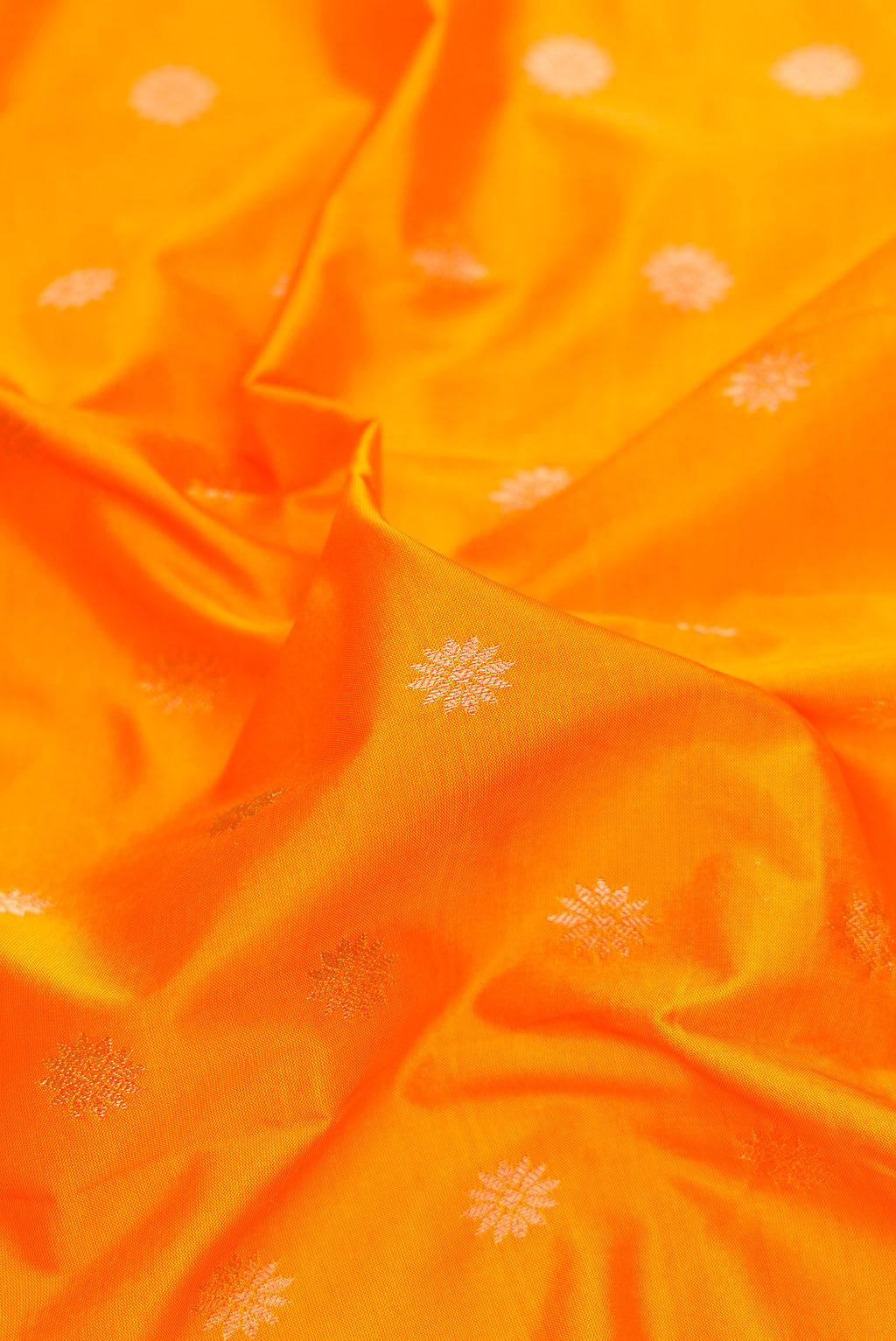Close up of Yellow Paithani Silk Saree with Zari Butta on the body and Zari Border.  displaying folds