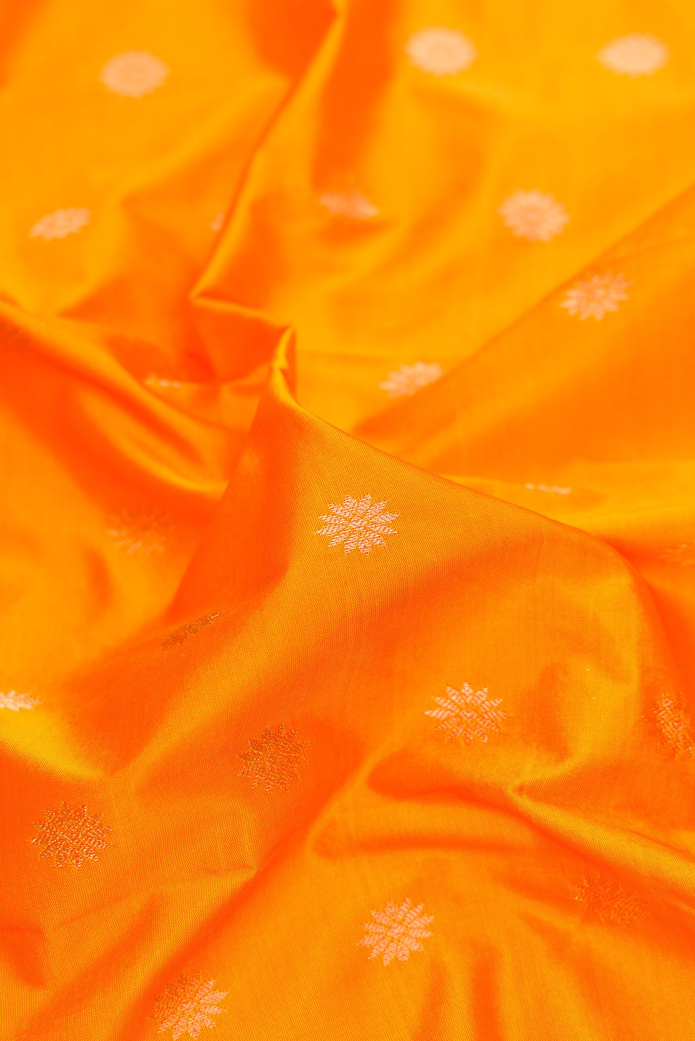 Close up of Yellow Paithani Silk Saree with Zari Butta on the body and Zari Border.  displaying folds
