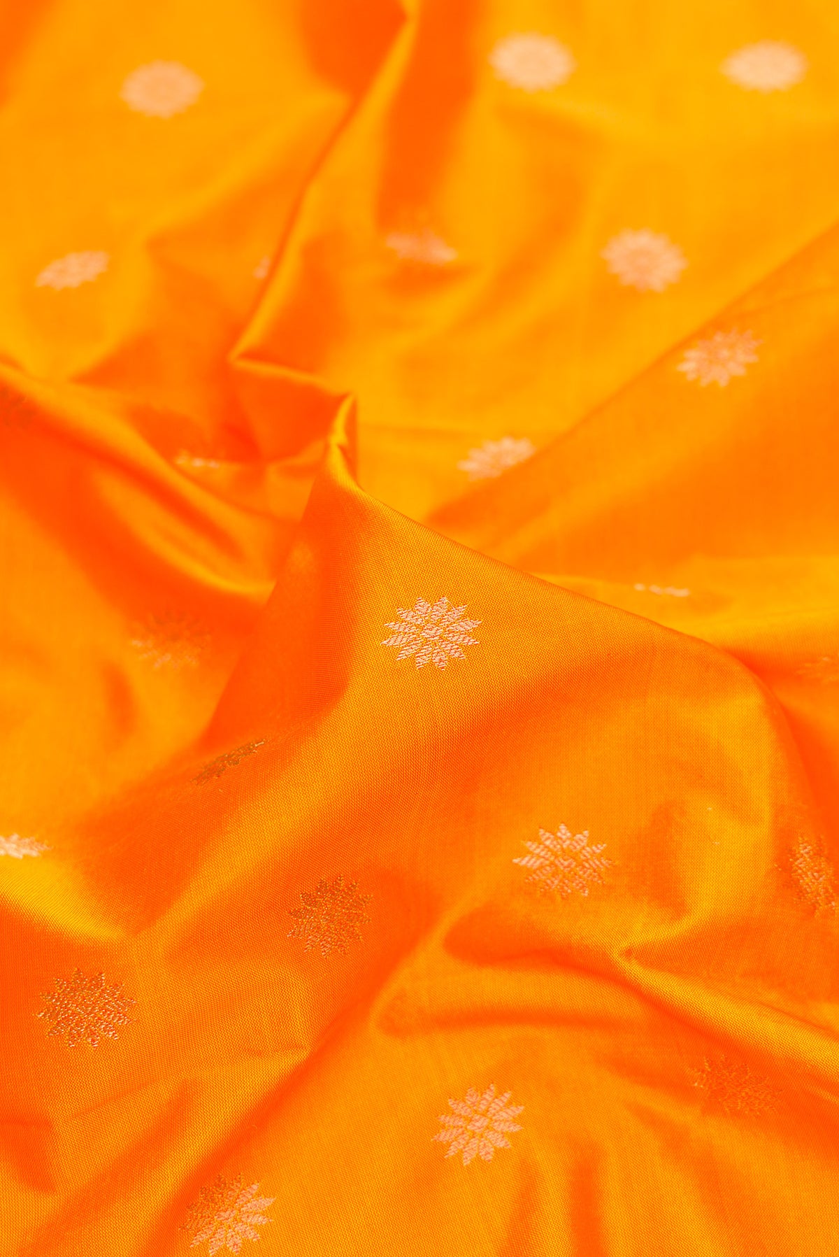 Close up of Yellow Paithani Silk Saree with Zari Butta on the body and Zari Border.  displaying folds