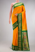 Yellow Paithani Silk Saree with Zari Butta on the body and Zari Border.  displayed on a mannequin