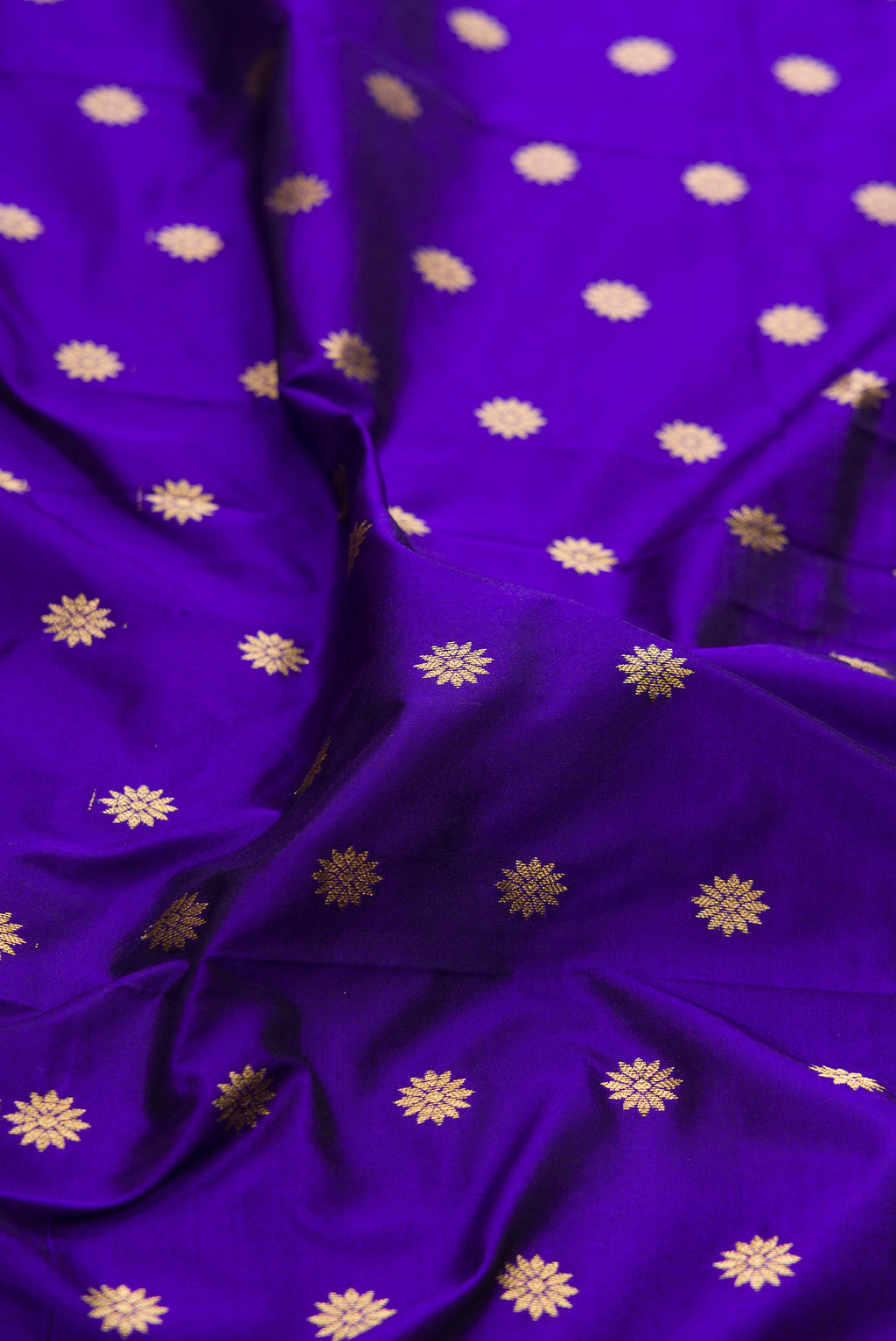 Close up of Royal Blue Paithani Silk Saree with Zari Butta on the body and Zari Border.  displaying folds