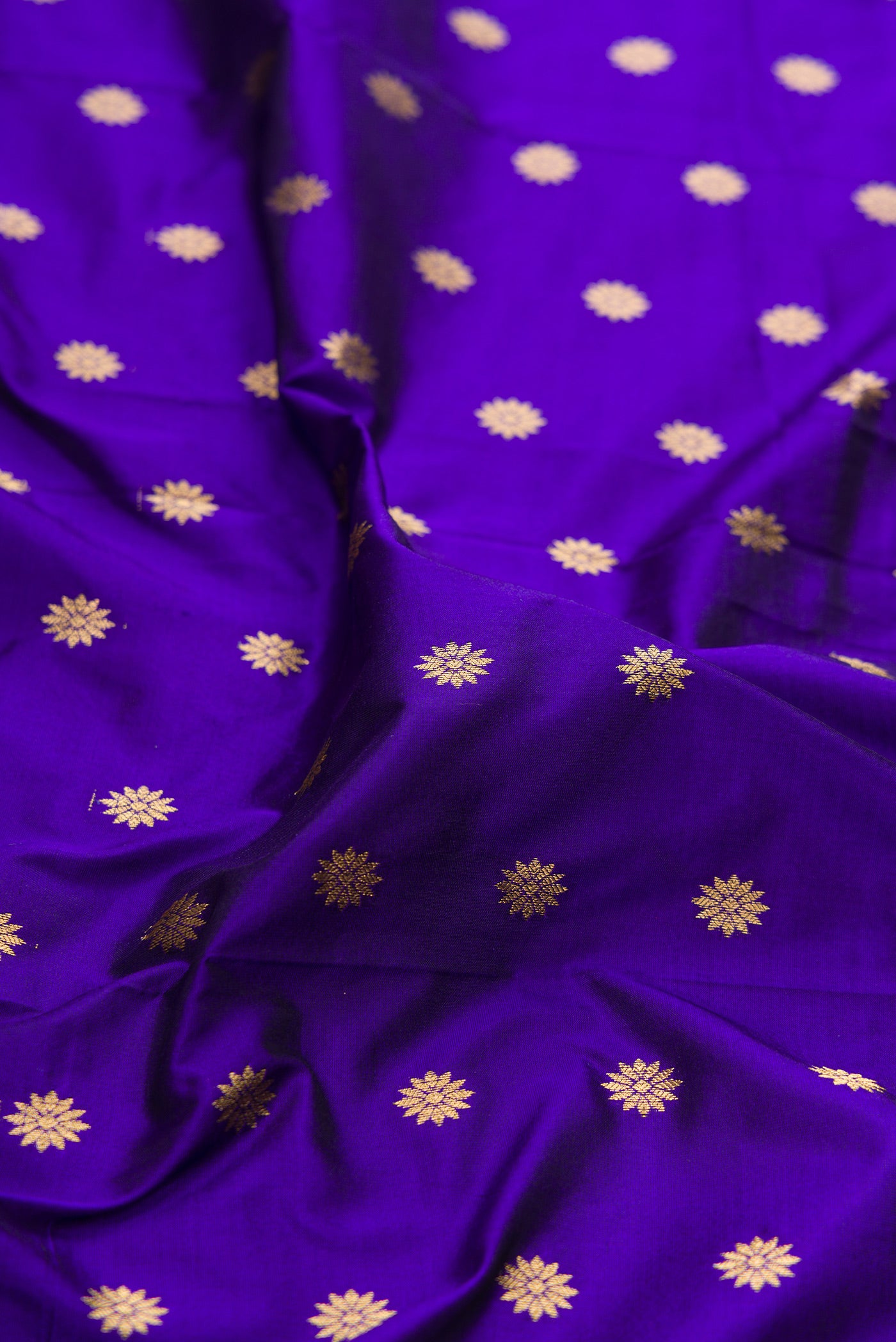 Close up of Royal Blue Paithani Silk Saree with Zari Butta on the body and Zari Border.  displaying folds