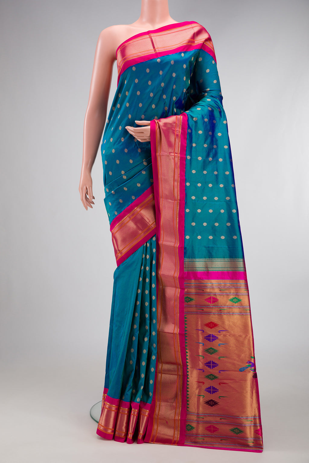Peacock Blue Paithani Silk Saree with Zari Butta on the body and Zari Border.  displayed on a mannequin