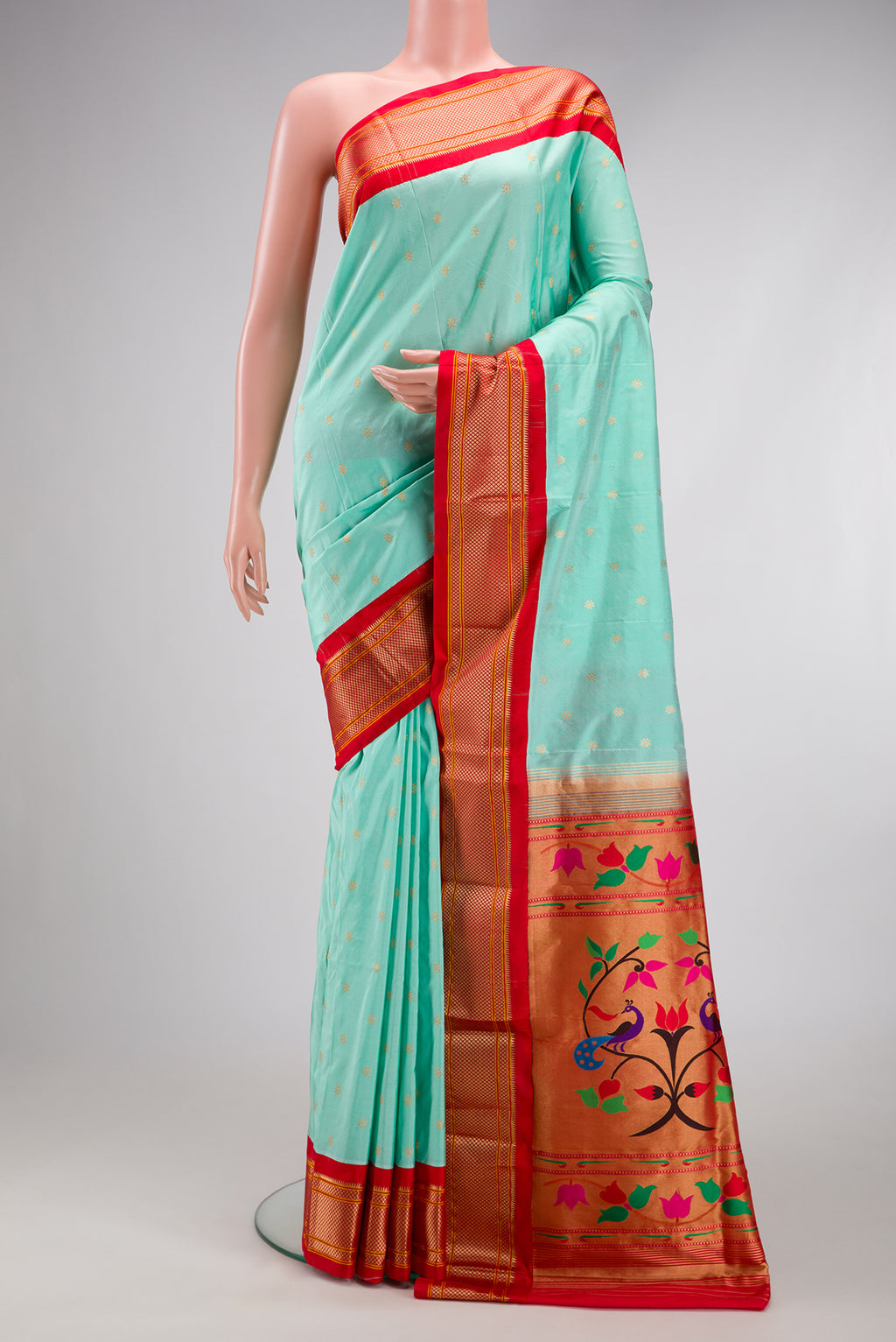 Light Blue Paithani Silk Saree with Zari Butta on the body and Zari Border.  displayed on a mannequin