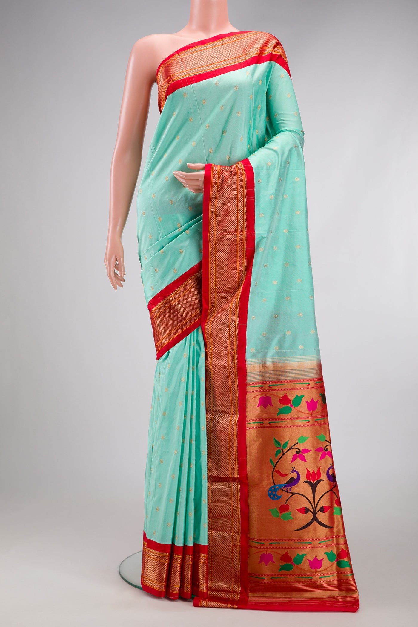 Light Blue Paithani Silk Saree with Zari Butta on the body and Zari Border.  displayed on a mannequin