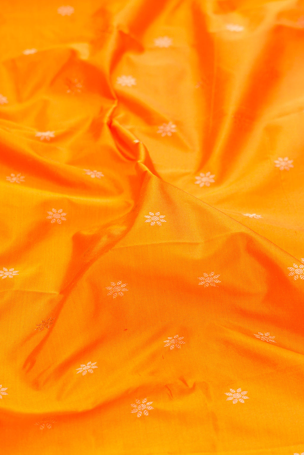 Close up of Yellow Dual Tone Paithani Silk Saree with Zari Butta on the body and Zari Border.  displaying folds
