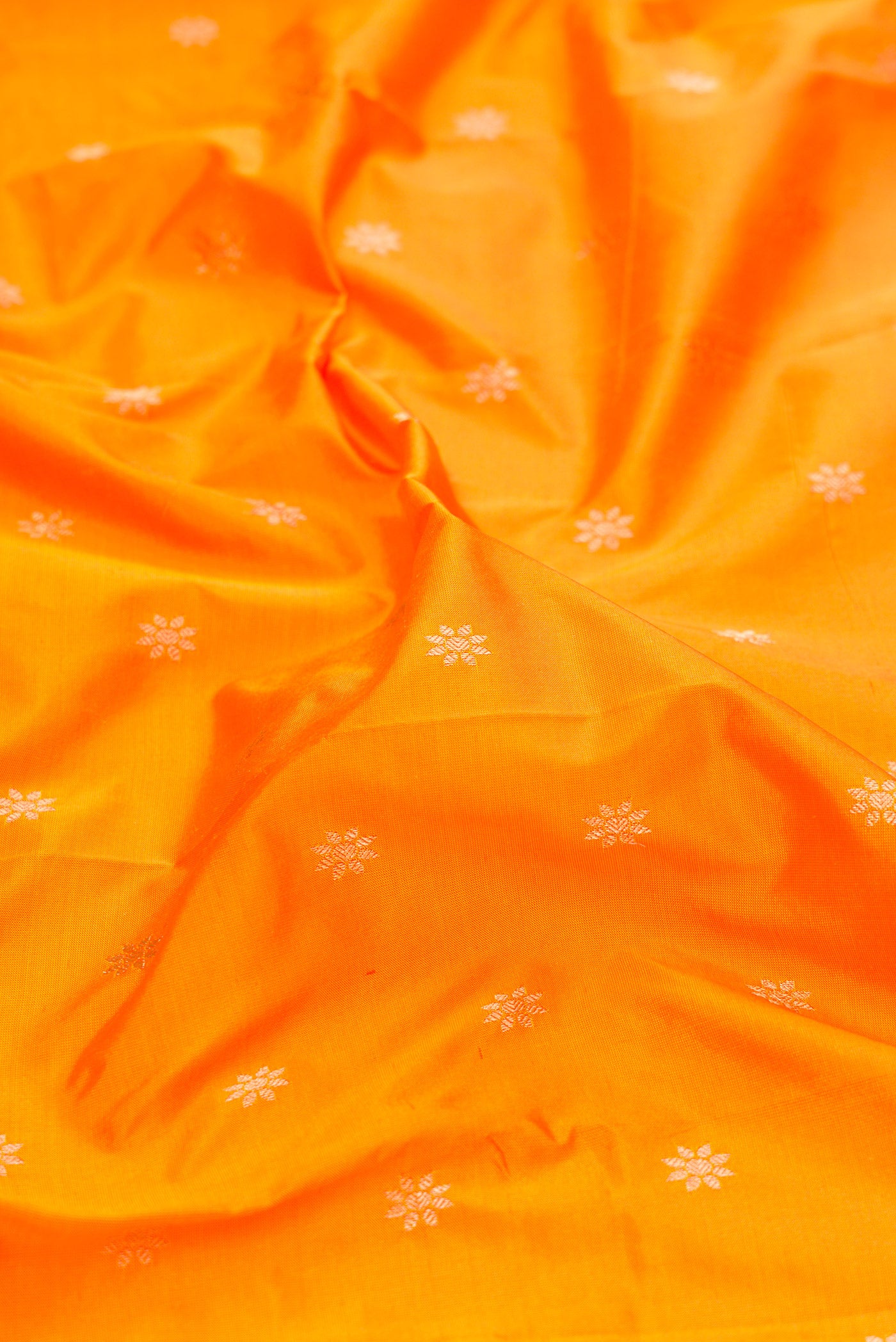 Close up of Yellow Dual Tone Paithani Silk Saree with Zari Butta on the body and Zari Border.  displaying folds