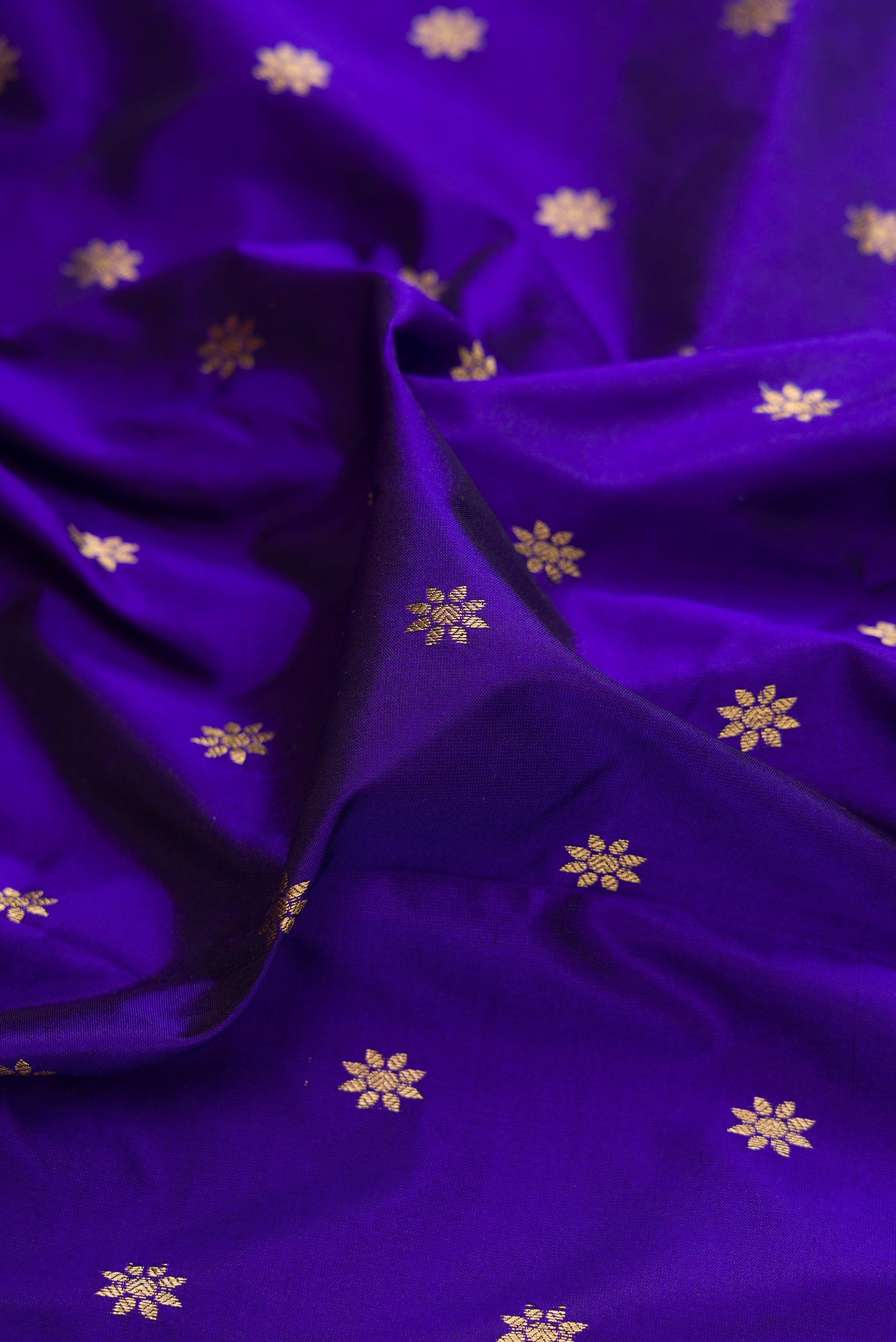 Close up of Royal Blue Paithani Silk Saree with Zari Butta on the body and Zari Border.  displaying folds