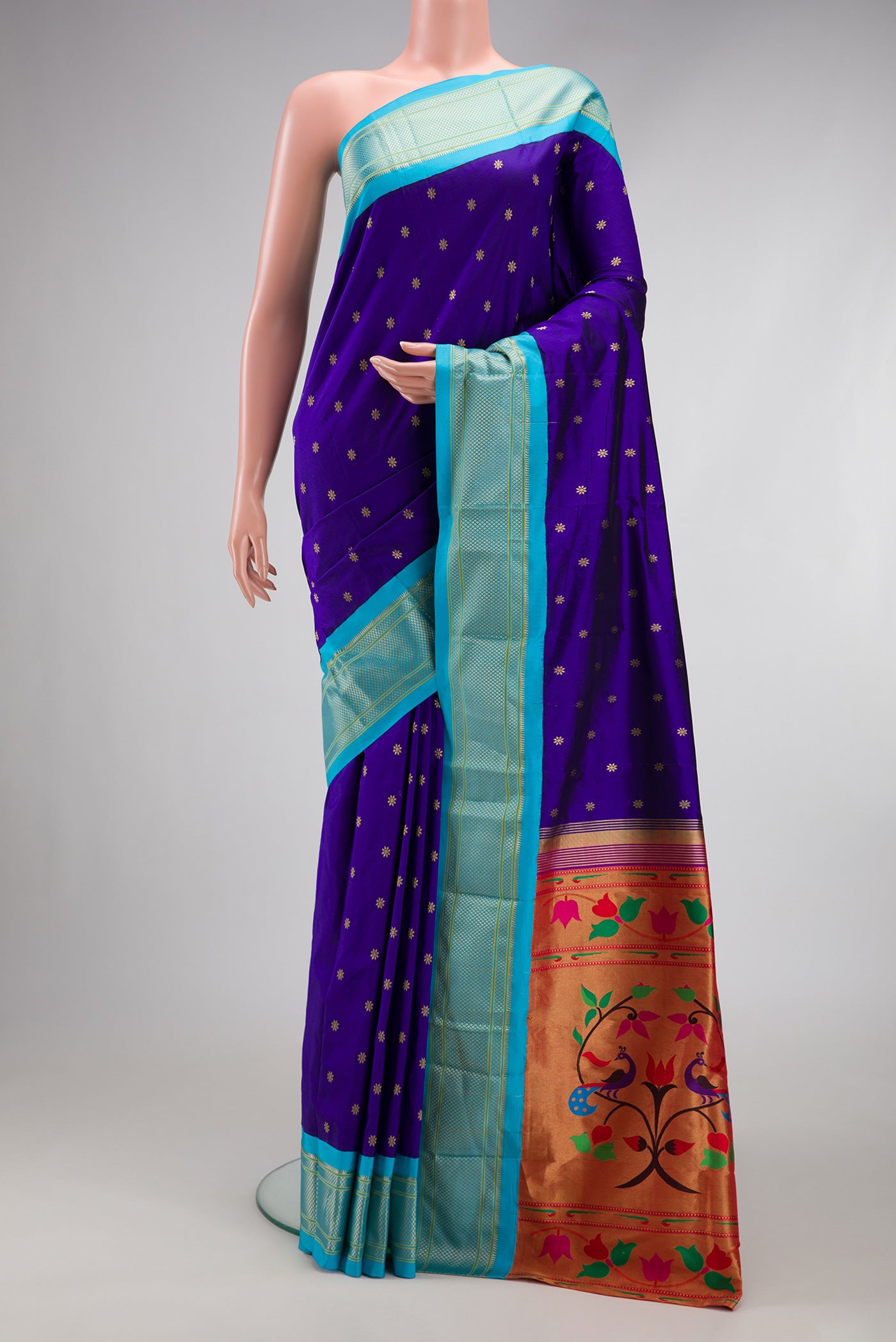 Royal Blue Paithani Silk Saree with Zari Butta on the body and Zari Border.  displayed on a mannequin