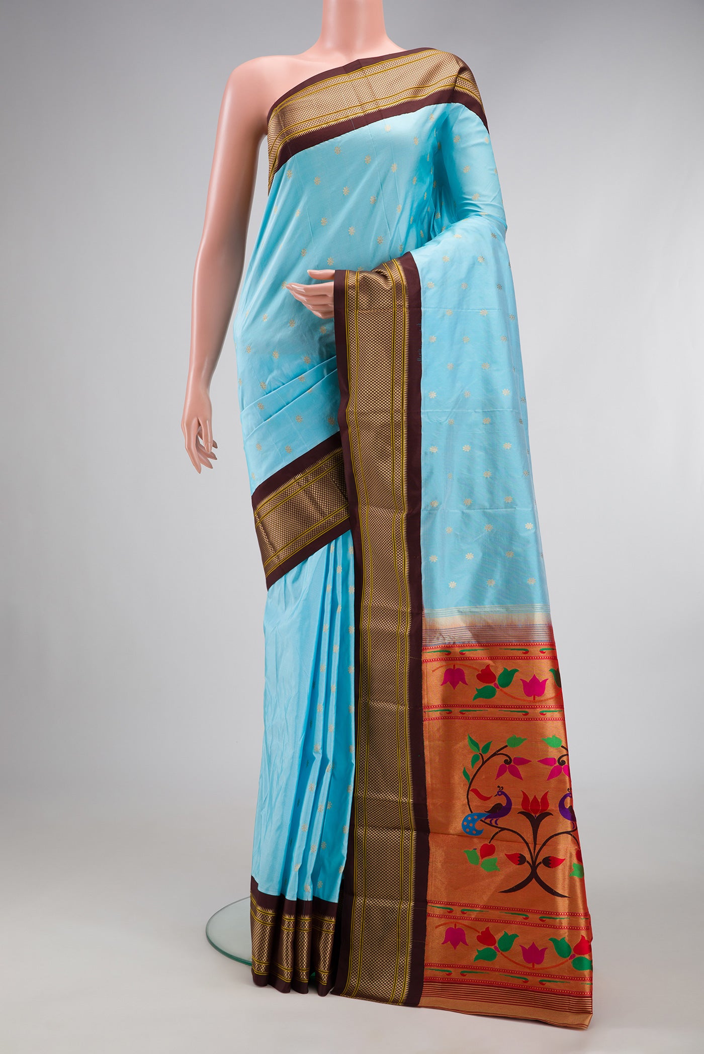 Sky Blue Paithani Silk Saree with Zari Butta on the body and Zari Border.  displayed on a mannequin