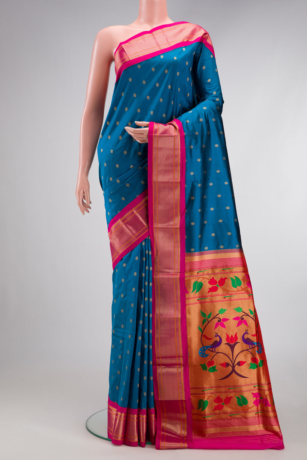 Peacock Blue Paithani Silk Saree with Zari Butta on the body and Zari Border.  displayed on a mannequin