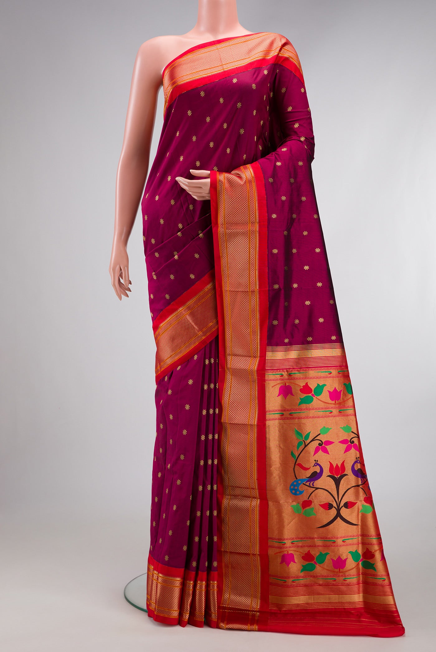 Magenta Paithani Silk Saree with Zari Butta on the body and Zari Border.  displayed on a mannequin