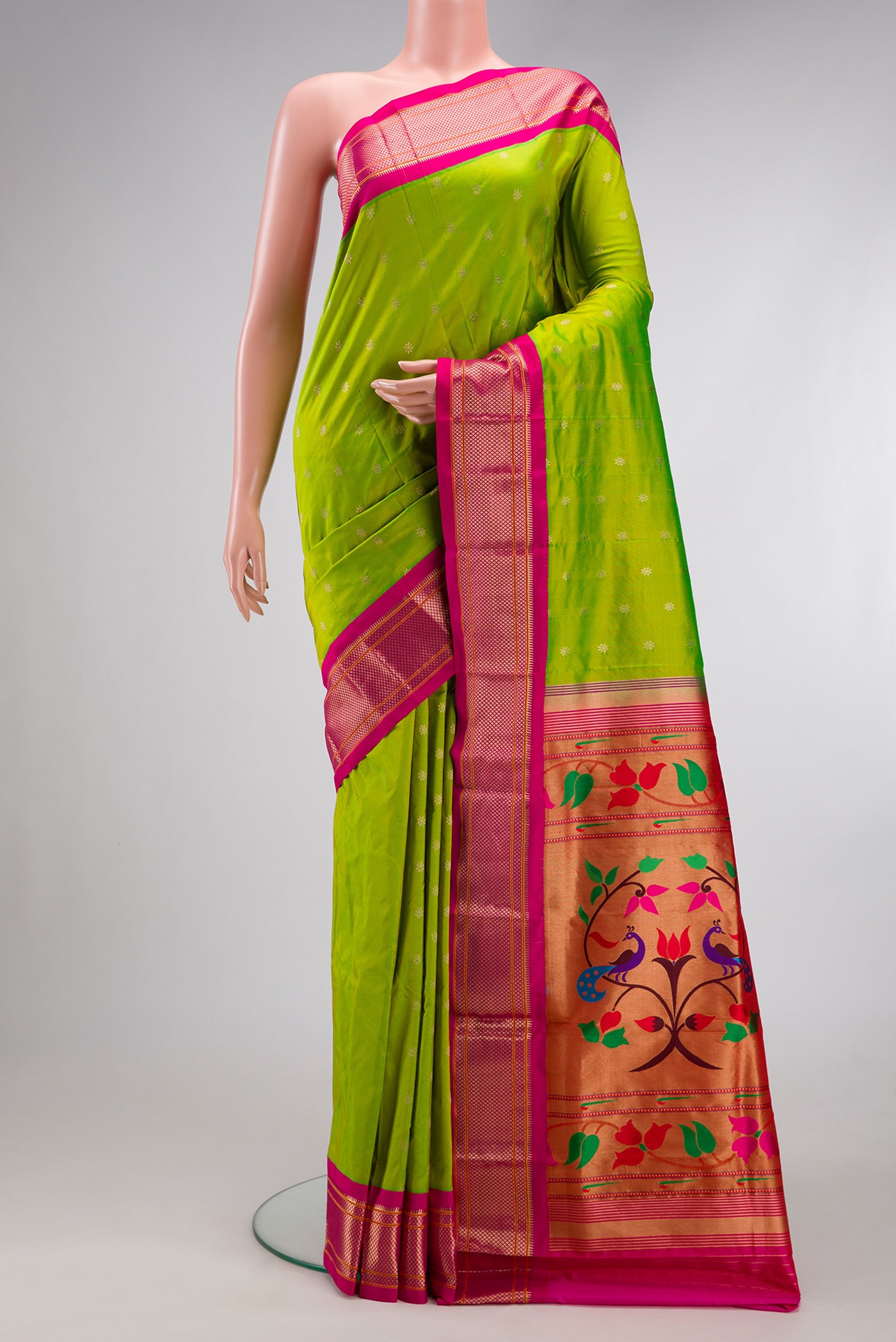 Parrot Green Paithani Silk Saree with Zari Butta on the body and Zari Border.  displayed on a mannequin