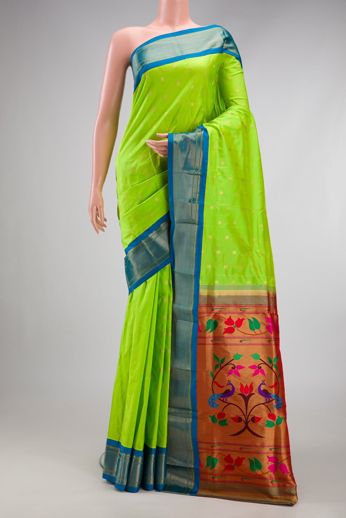 Parrot Green Paithani Silk Saree with Zari Butta on the body and Zari Border.  displayed on a mannequin