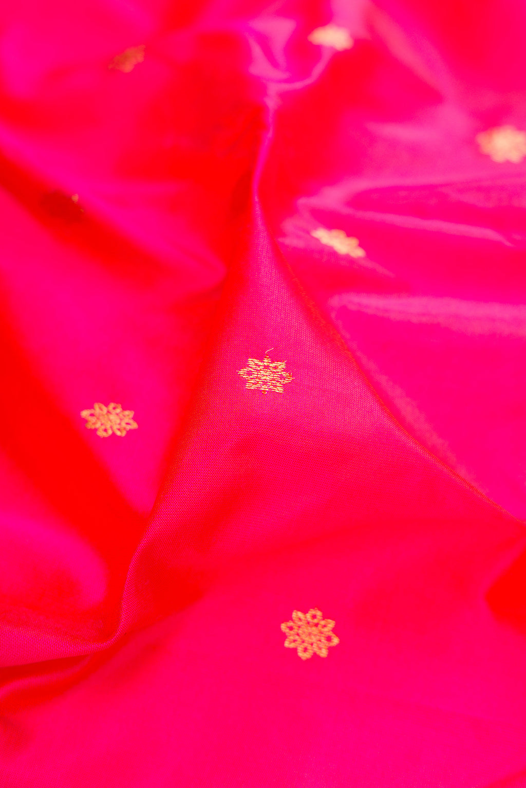 Close up of Dark Pink Paithani Silk Saree with Zari Butta on the body and Zari Border.  displaying folds
