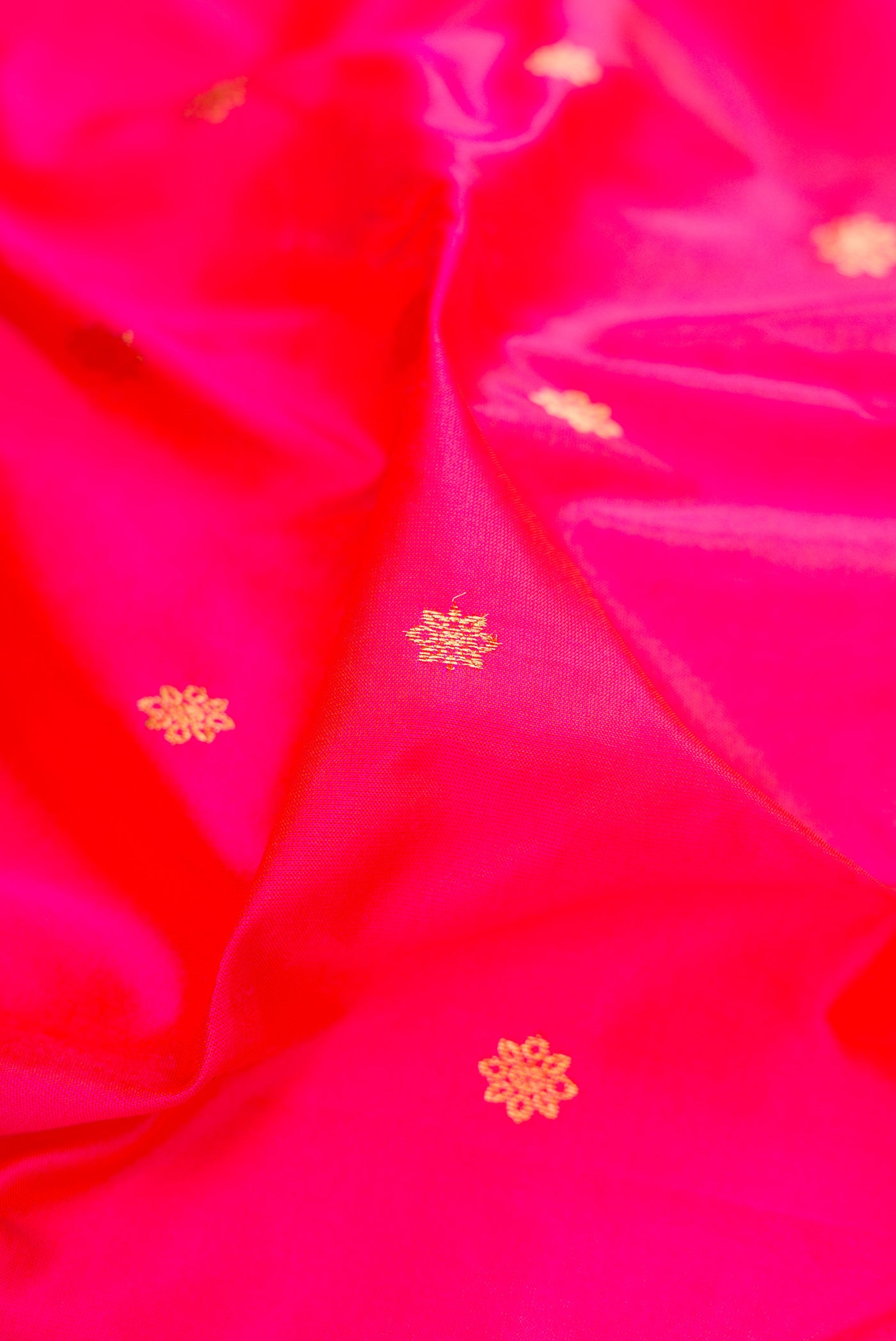 Close up of Dark Pink Paithani Silk Saree with Zari Butta on the body and Zari Border.  displaying folds