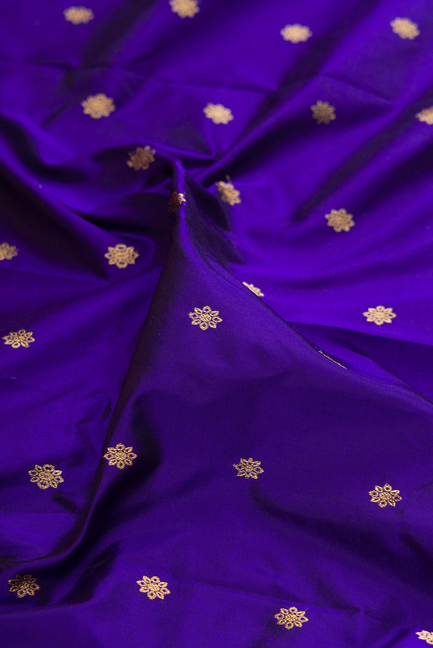 Close up of Blue Paithani Silk Saree with Zari Butta on the body and Zari Border.  displaying folds