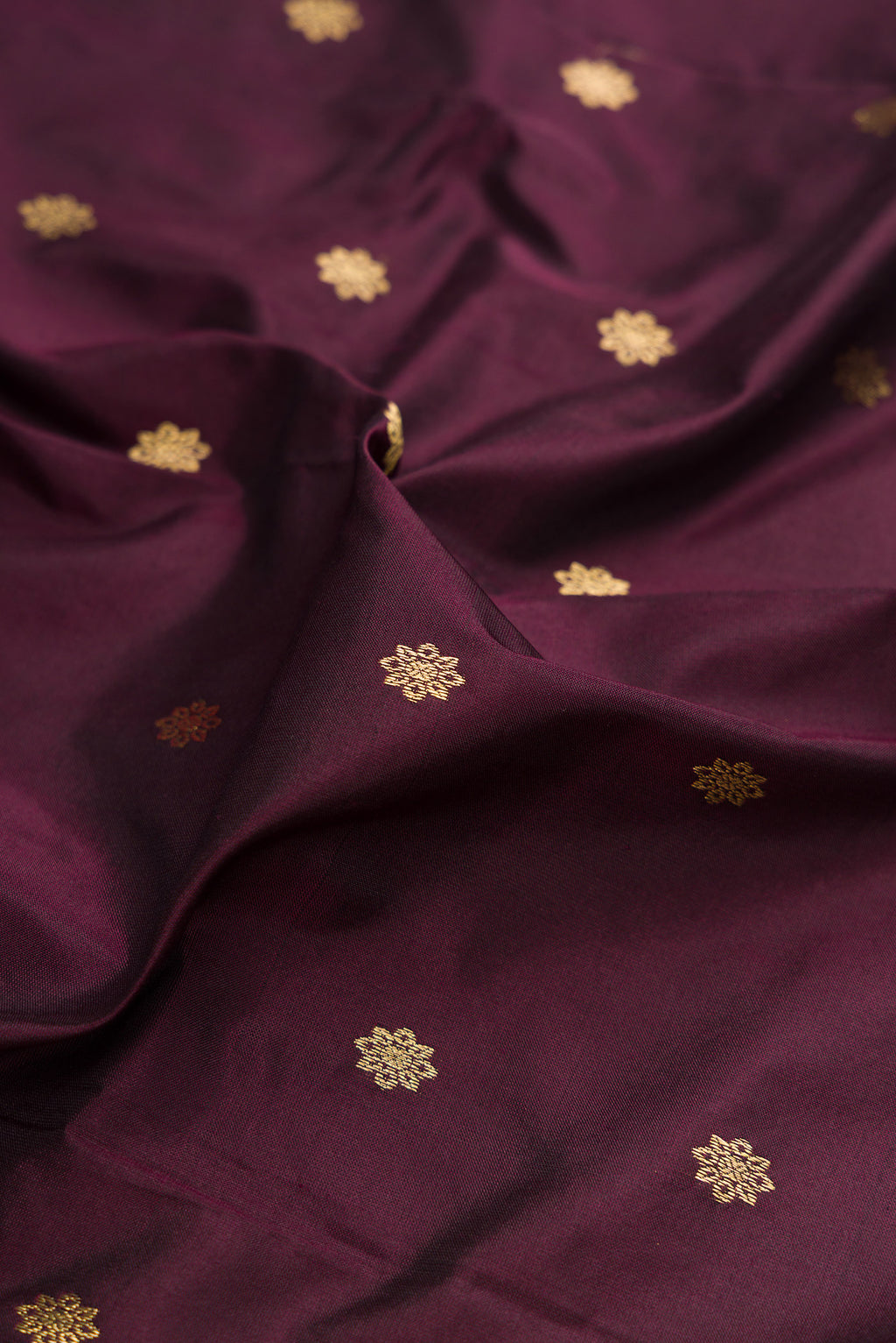 Close up of Coffee Brown Paithani Silk Saree with Zari Butta on the body and Zari Border.  displaying folds